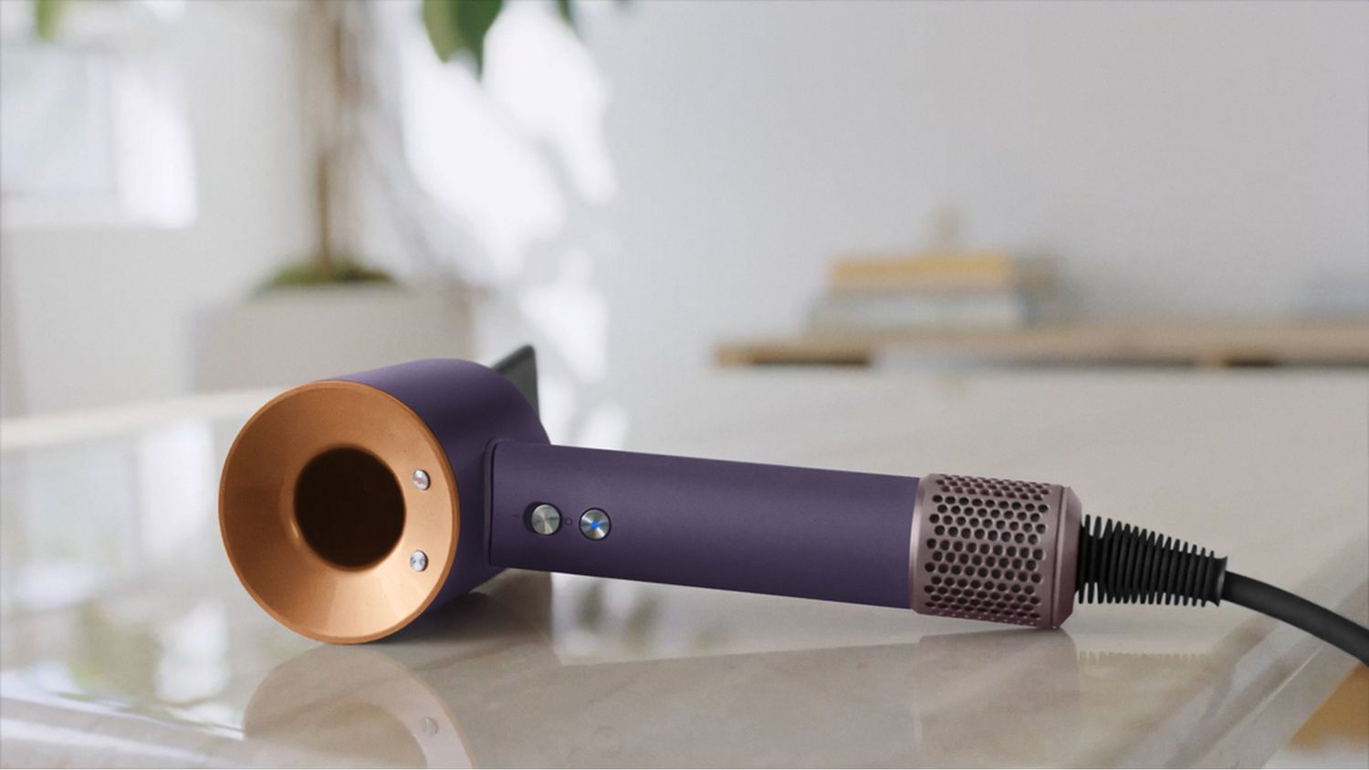 The Dyson Supersonic Professional hair dryer in Bright copper on a counter.
