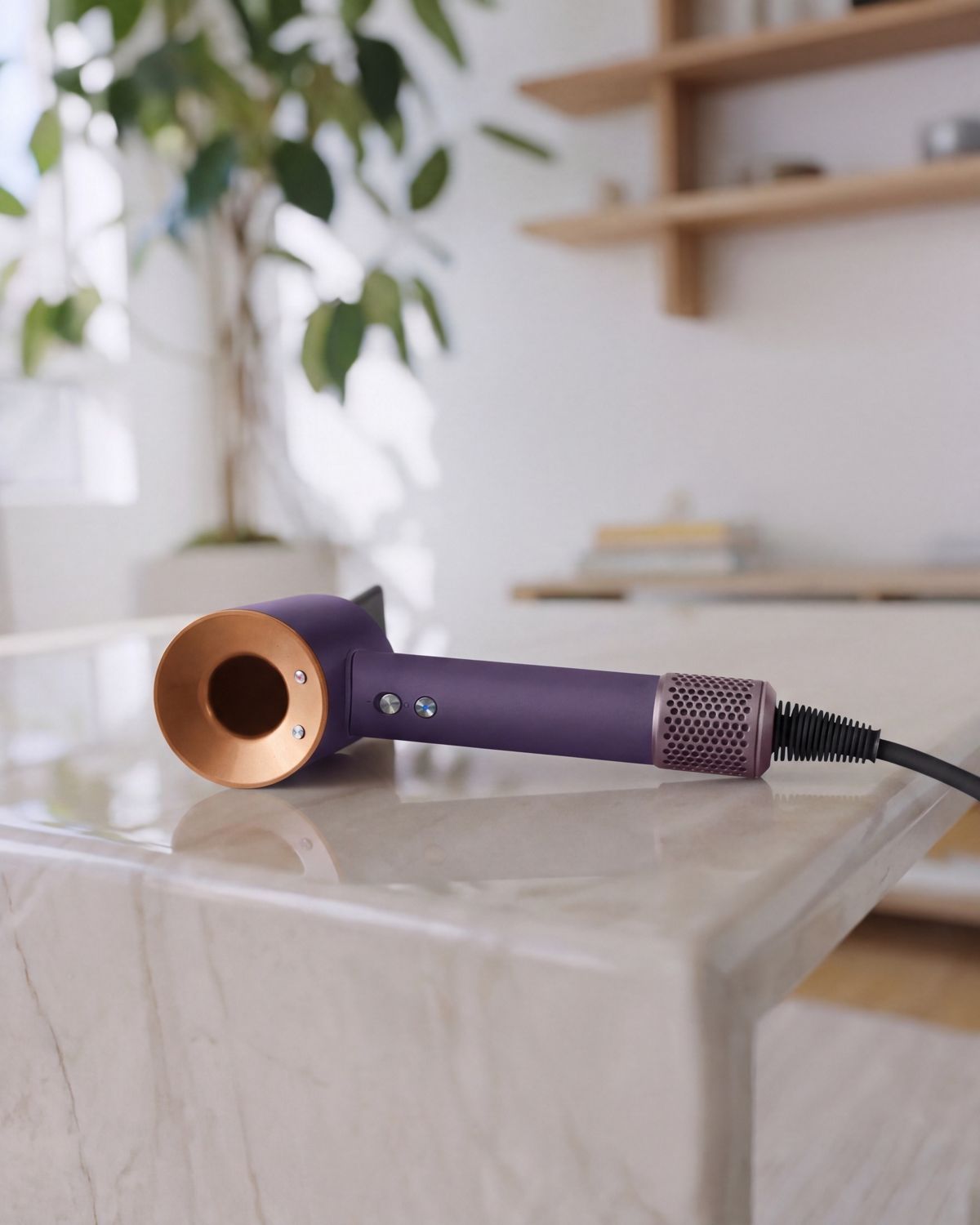 The Dyson Supersonic Professional hair dryer in Bright copper on a counter.