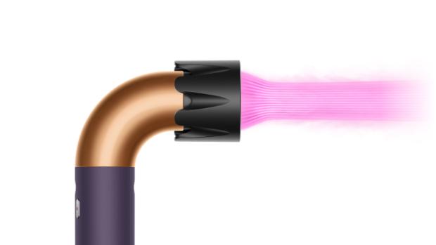 The Dyson Supersonic r Professional hair dryer in Bright copper with the Powerful air attachment.