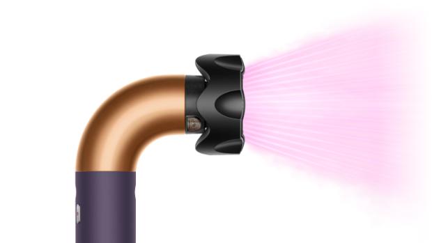 The Dyson Supersonic r Professional hair dryer in Bright copper with the Gentle air attachment.