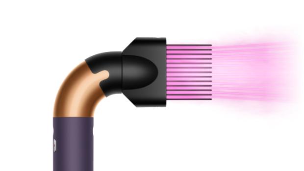 The Dyson Supersonic r Professional hair dryer in Bright copper with the Wide-tooth comb attachment.