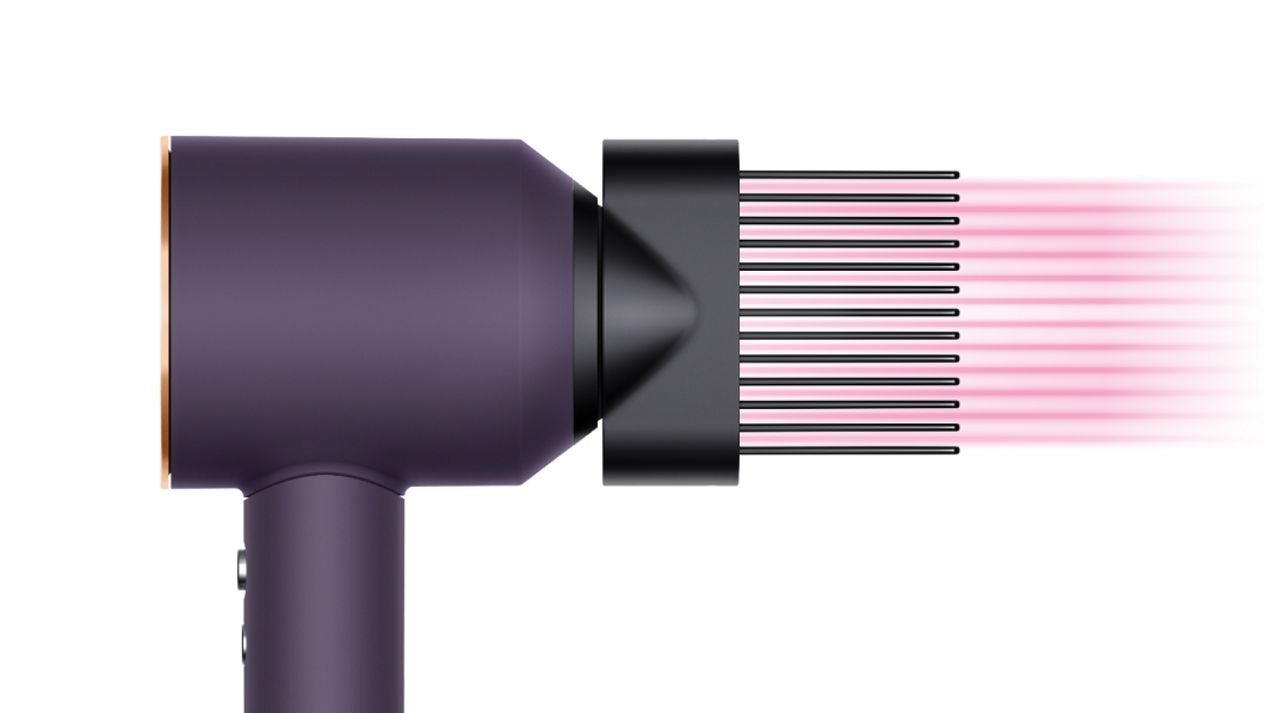 The Dyson Supersonic Professional hair dryer in Bright copper with the Wide-tooth comb attachment. The Dyson Supersonic Professional hair dryer in Bright copper with the Wide-tooth comb attachment.
