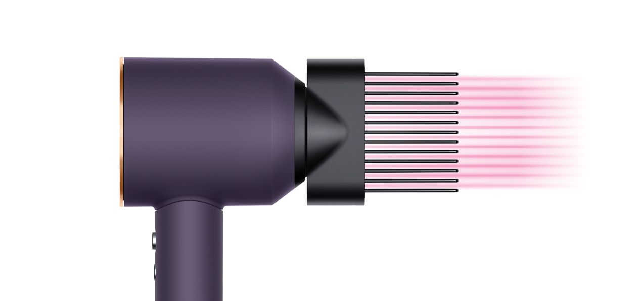 The Dyson Supersonic Professional hair dryer in Bright copper with the Wide-tooth comb attachment.