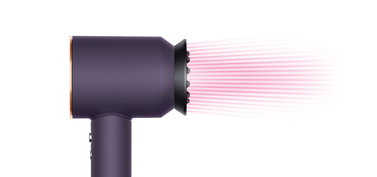 The Dyson Supersonic Professional hair dryer in Bright copper with the Gentle air attachment.