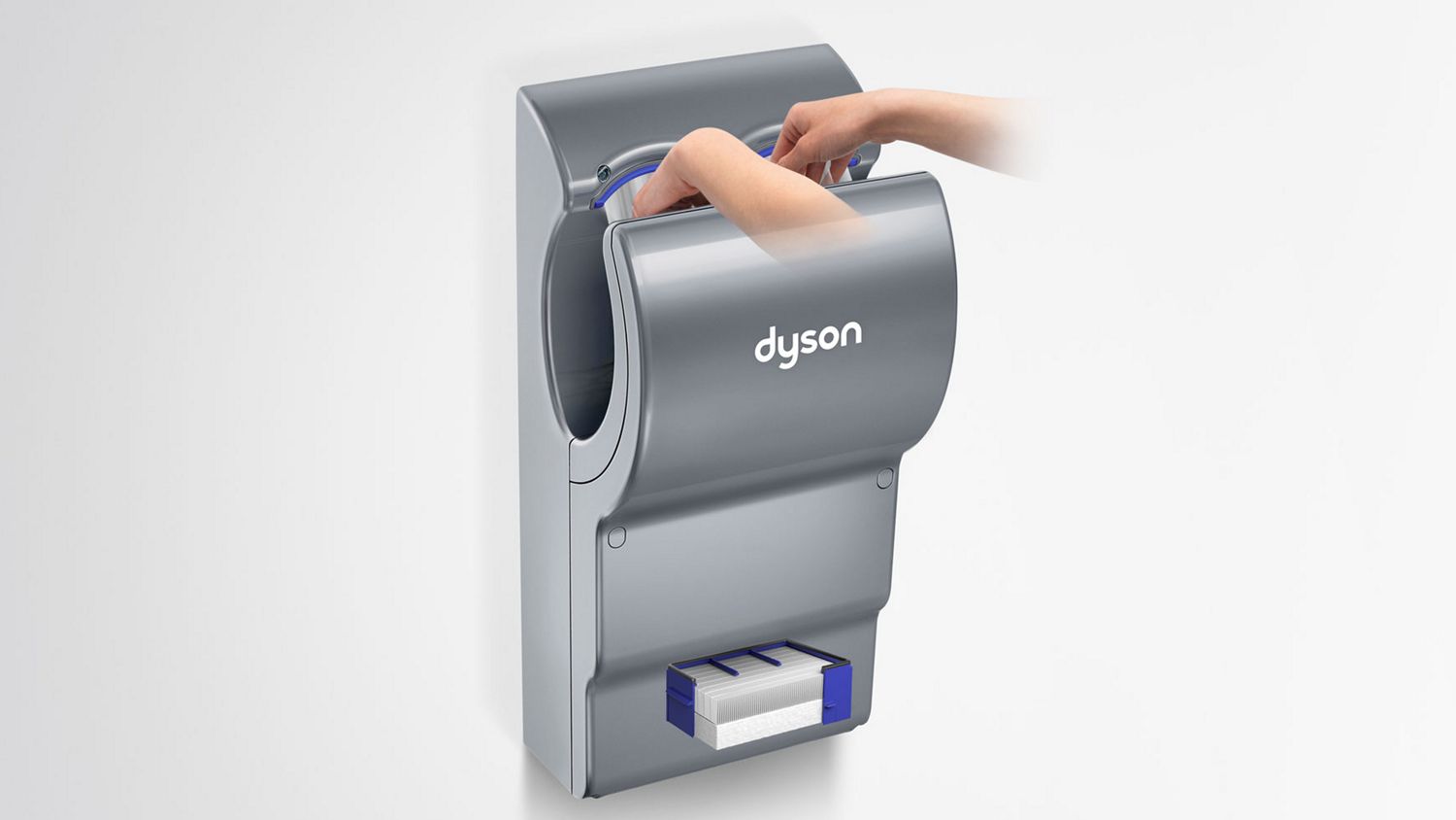 A person dries their hands in the Dyson Airblade dB hand dryer.