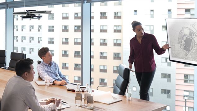 Woman presenting with the use of Dyson Cu-Beam lighting 