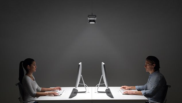 Two people at desks working under Dyson Cu-Beam lighting