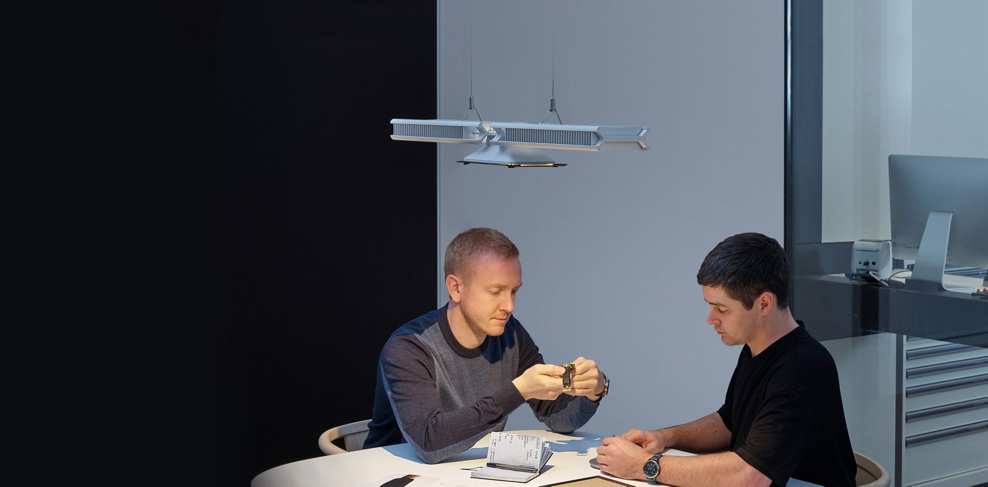 Two men working under the Dyson Cu-Beam light