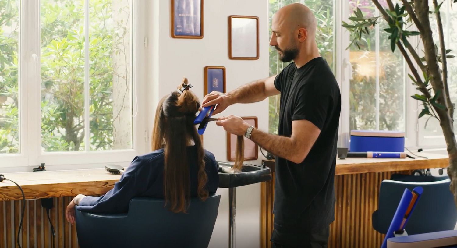 Stylist using the Dyson Corrale Professional