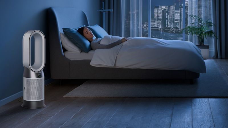 A Dyson air purifier in a bedroom at night.