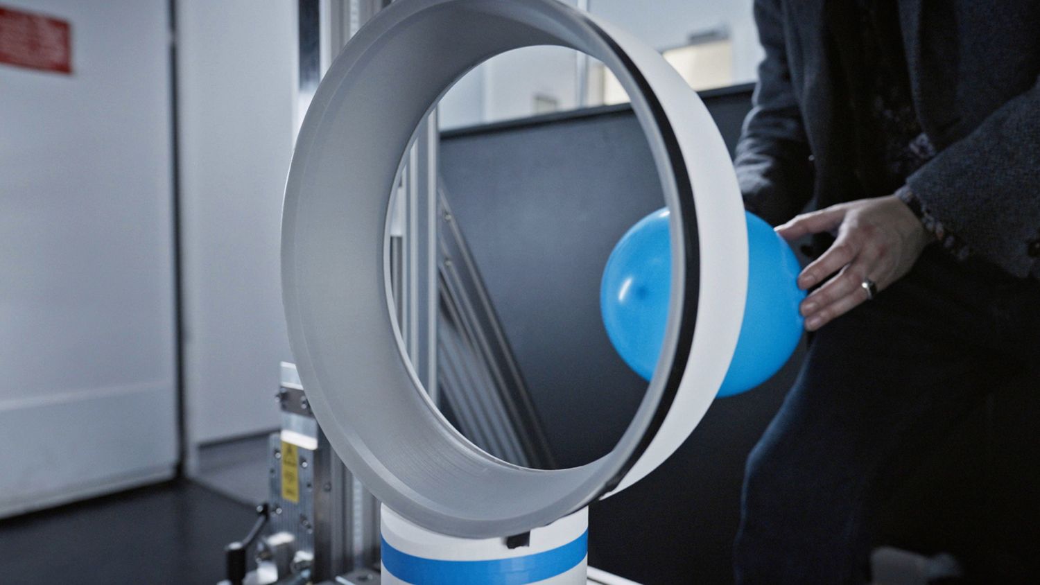 A blue balloon passing through the Dyson Cool CF1 fan.