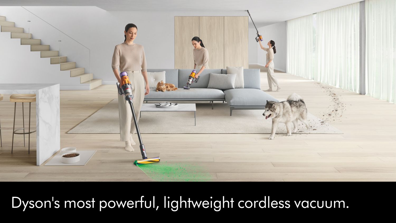 A Dyson V12 vacuum cleaner is used by a pet-owner to clean around her home.