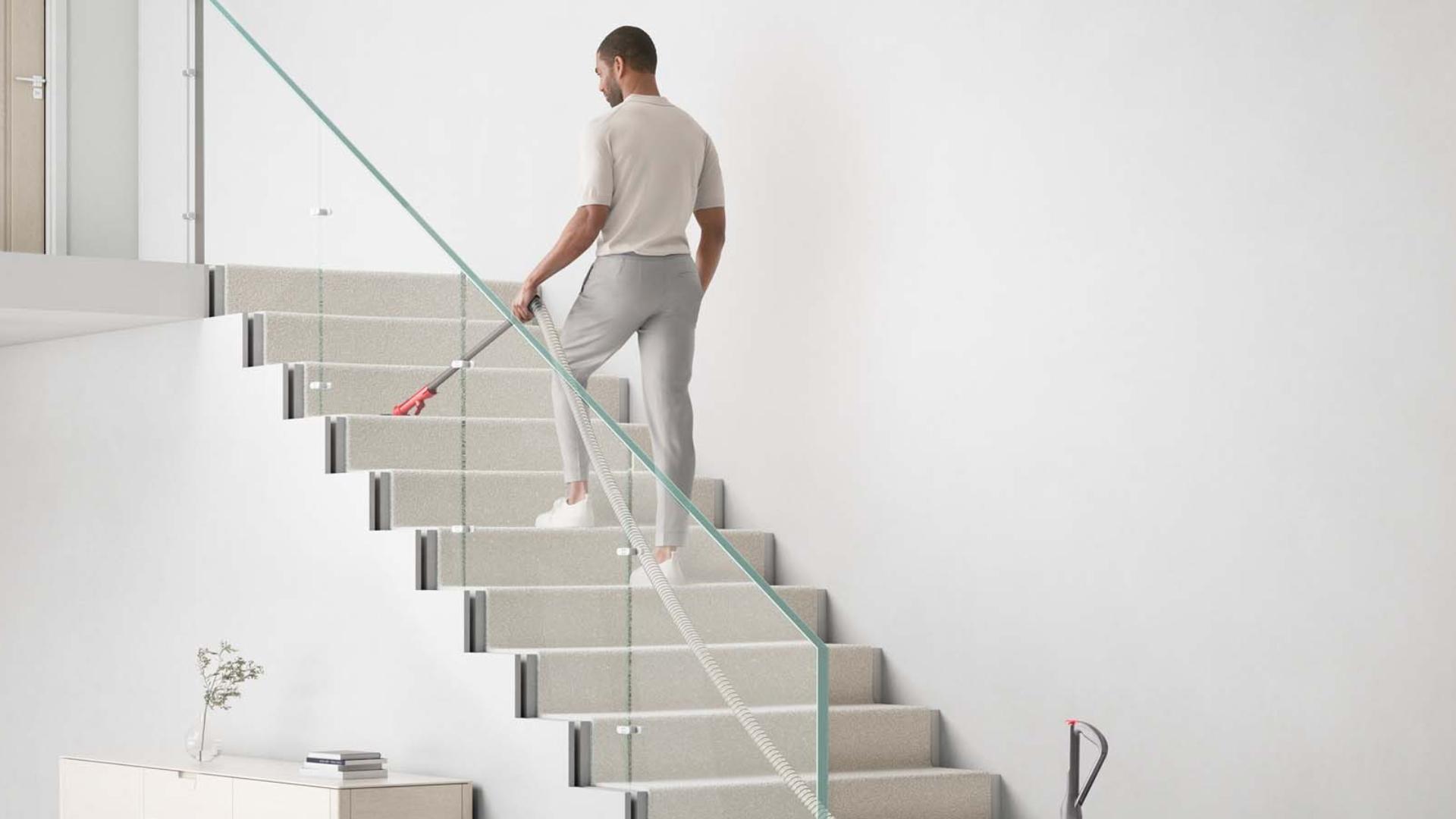 A Dyson ball animal being used to clean stars with its extending hose