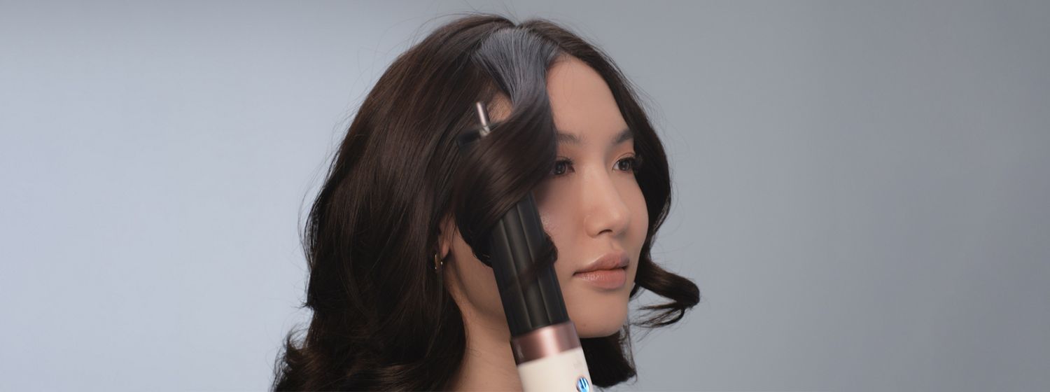 The Dyson Airwrap Co-anda2x multi-styler and dryer is used to style a model’s hair.
