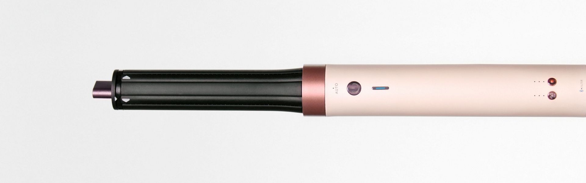 Splitscreen of the Dyson Airwrap Co-anda2x multi-styler and dryer, and a blonde model with hair styled with the device.