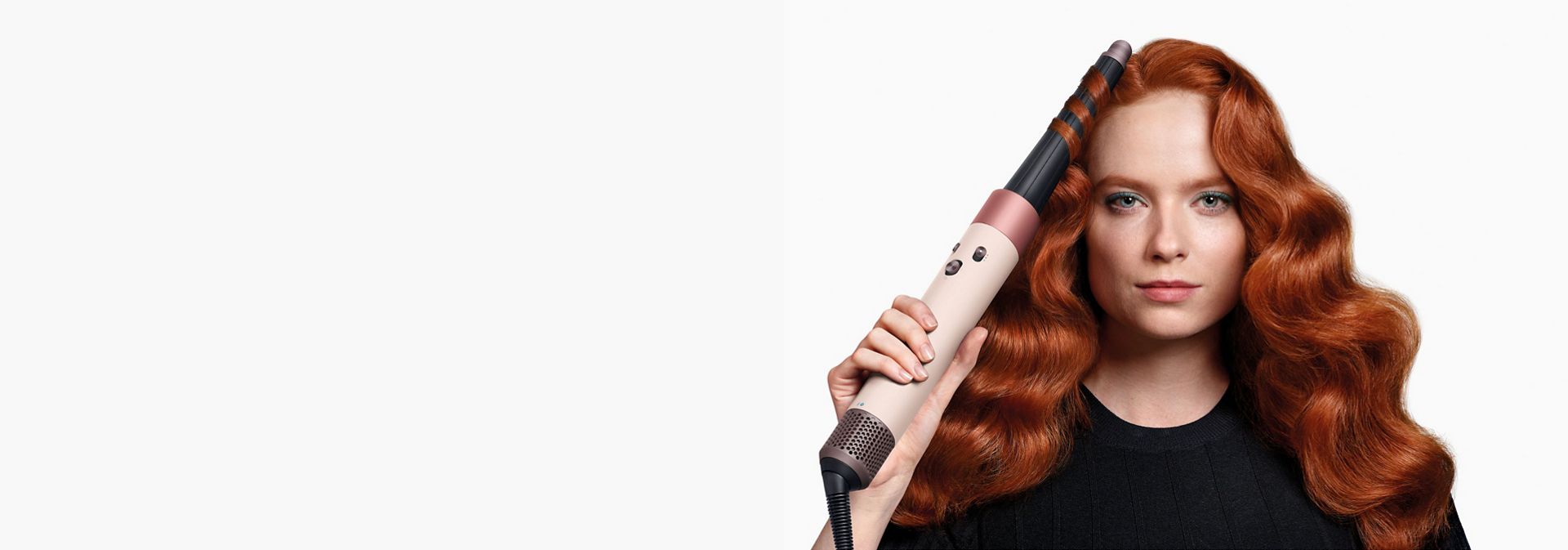 Dyson Airwrap i.d. multi-styler and dryer used by a model to style her hair.