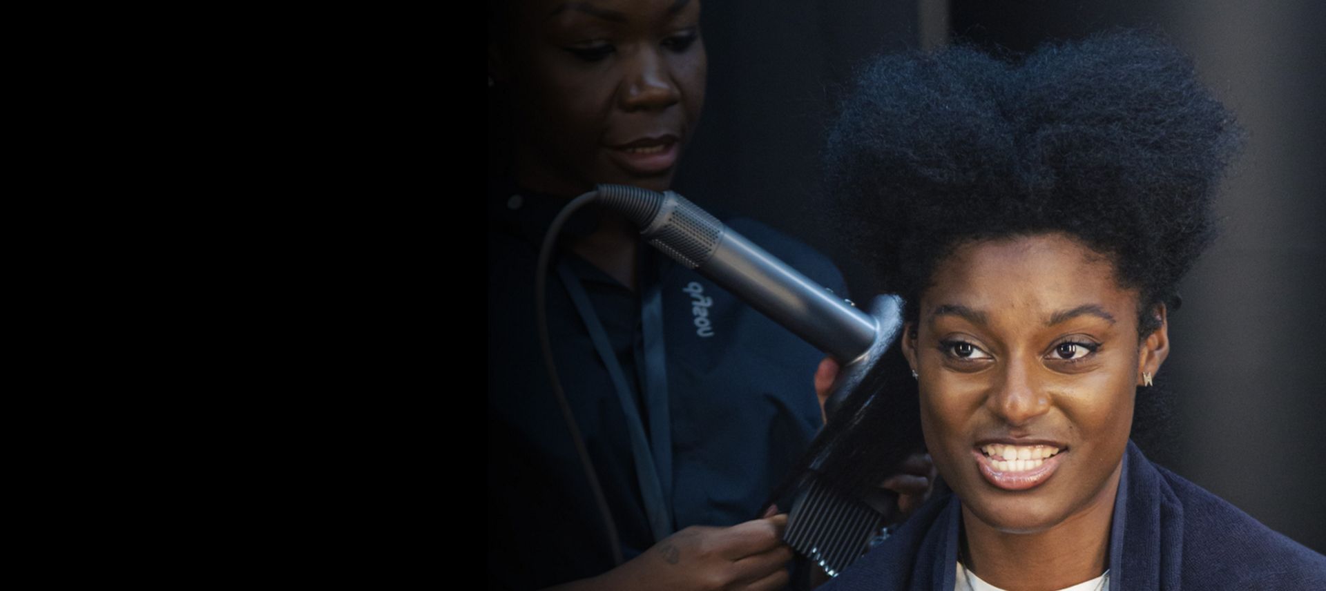 Dyson expert styling a customer's hair