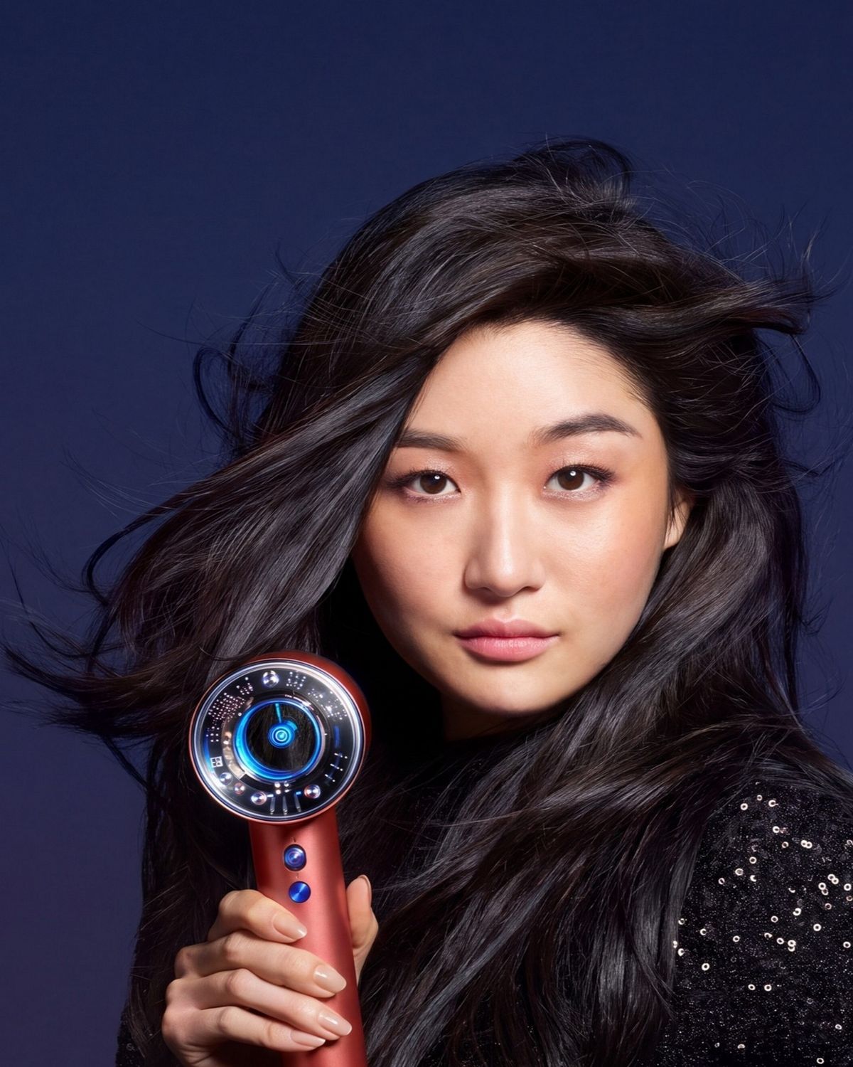 The Dyson Supersonic Nural hair dryer held by a model.