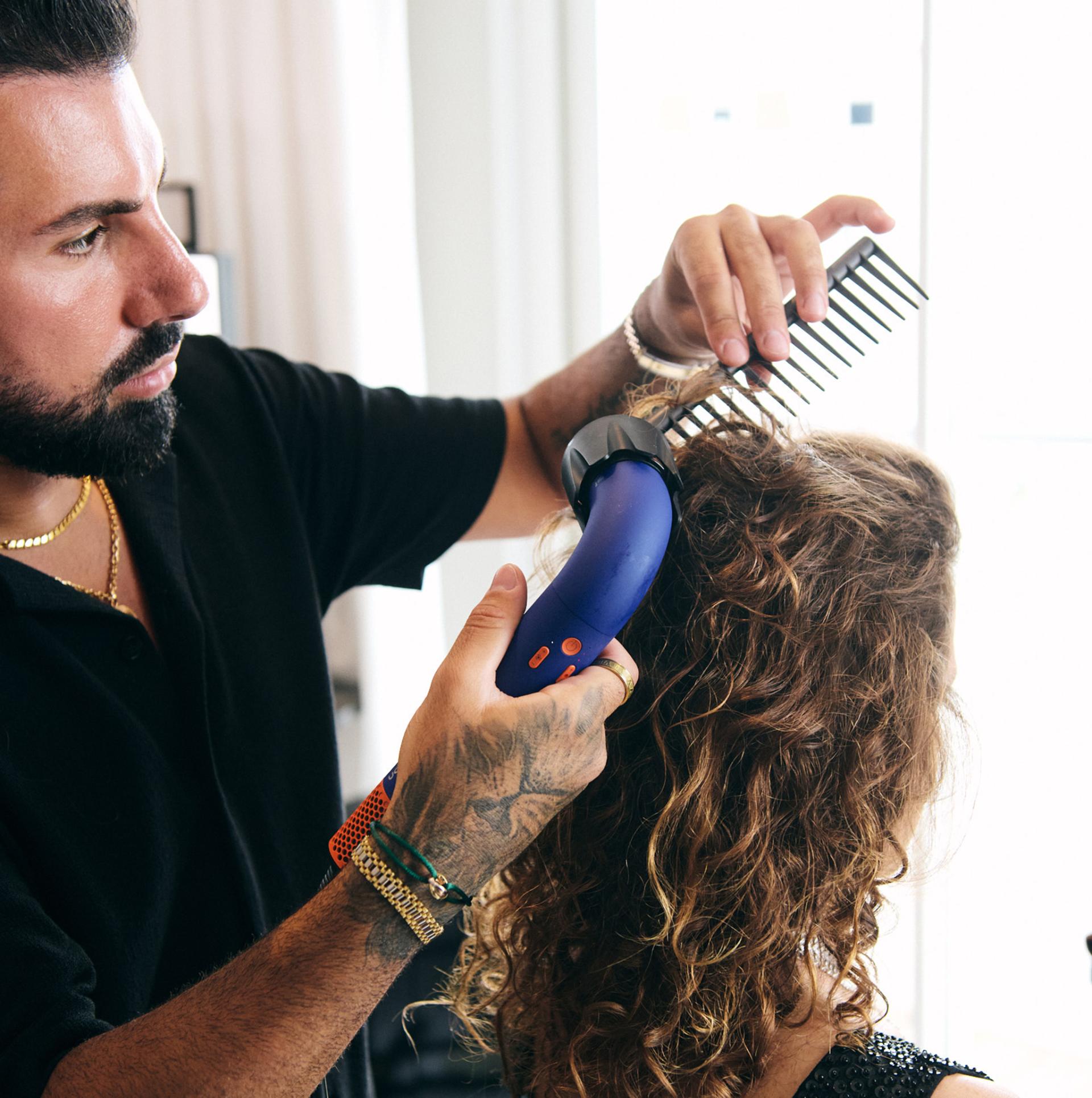 Sebastian styling model hair with supersonic r