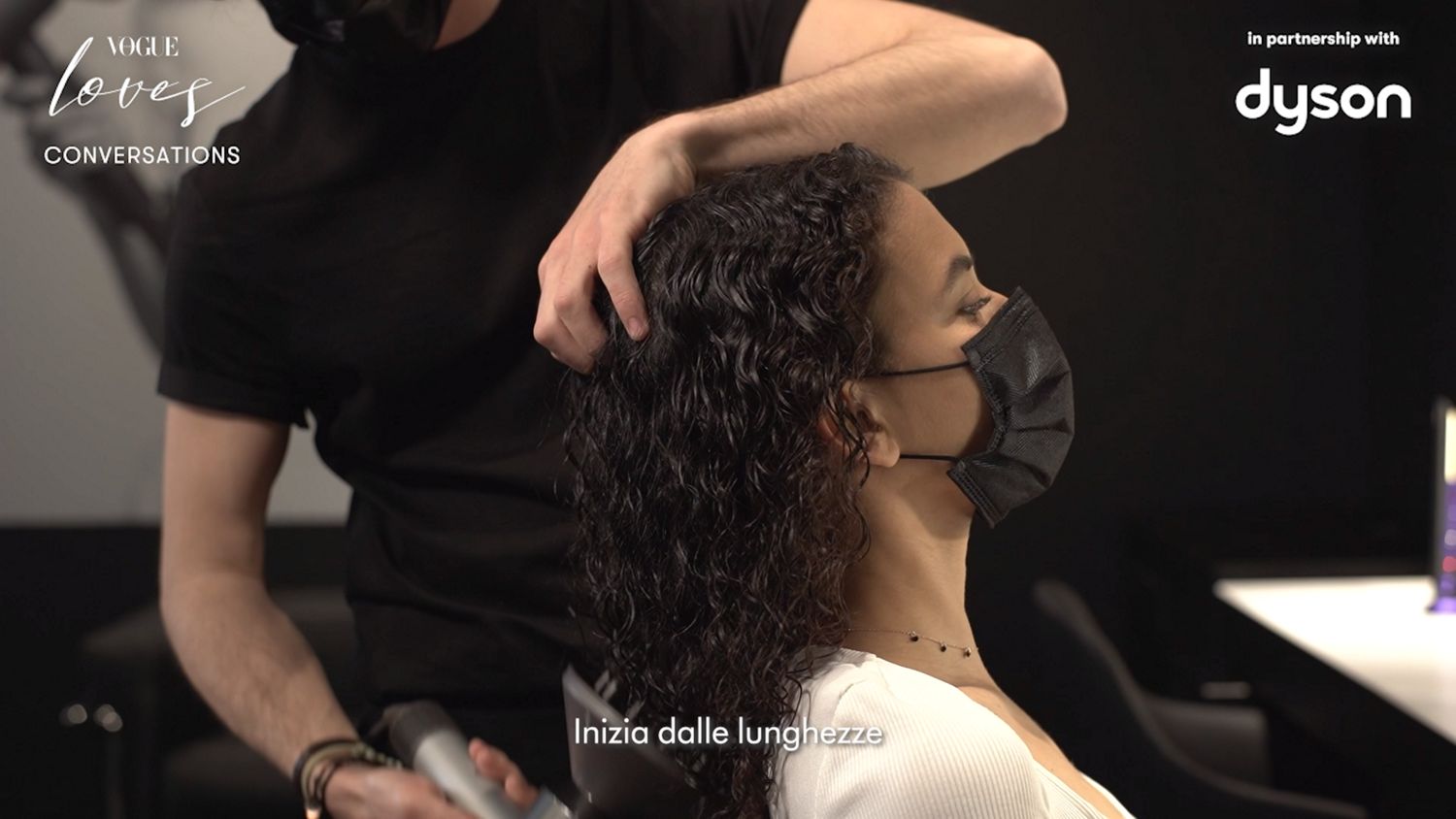 A model get their hair styled.