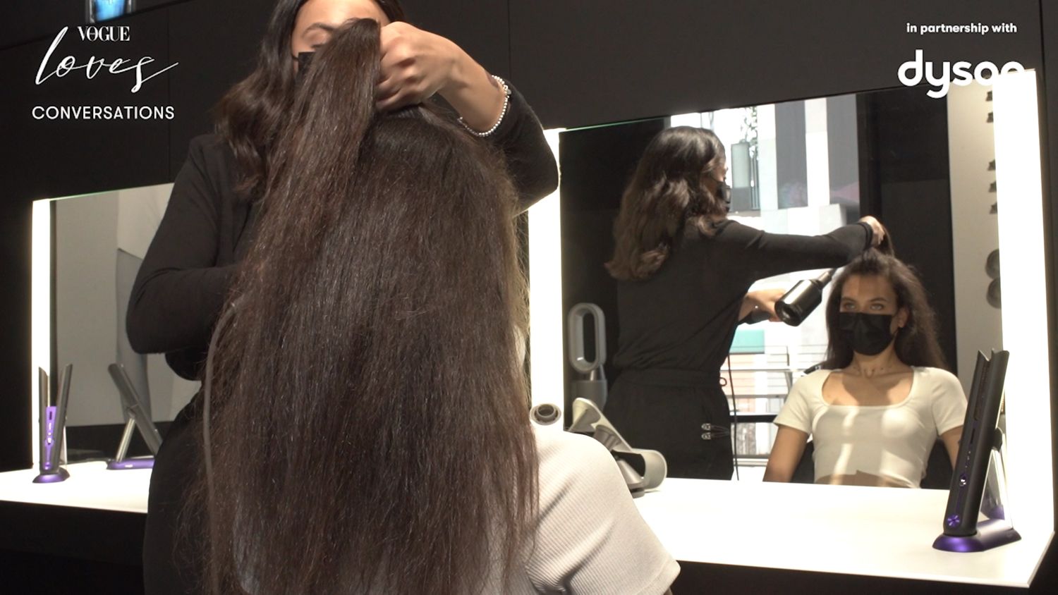 A model get their hair styled.
