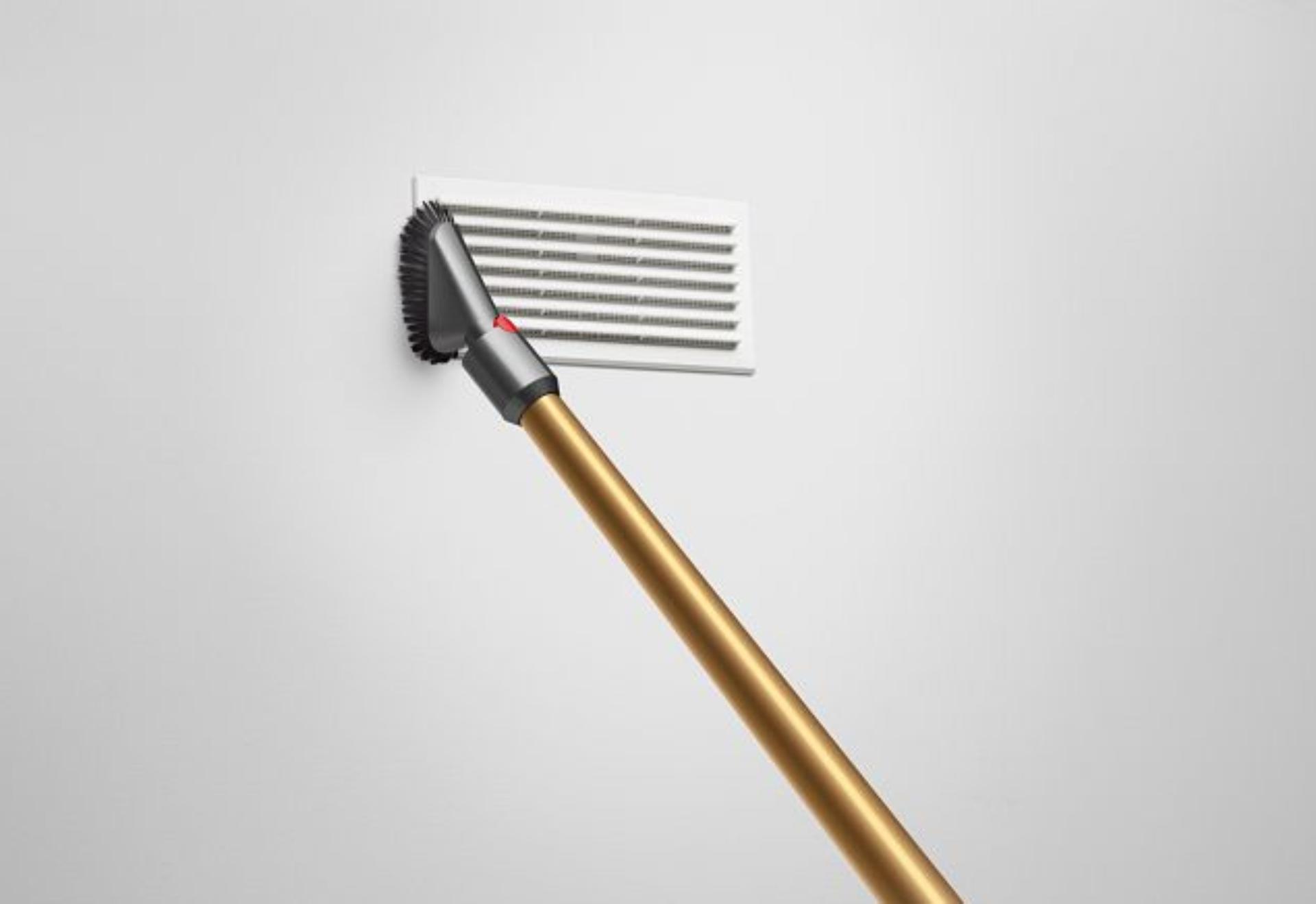Dyson vacuum being used to clean vent
