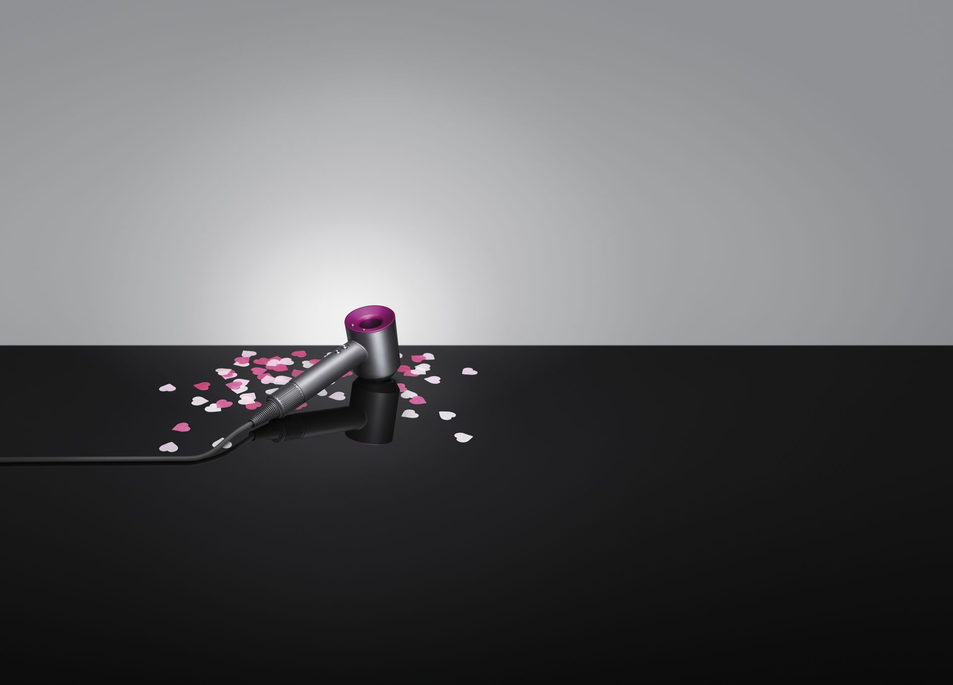 A Dyson Supersonic laying on Valentine's Day hearts.