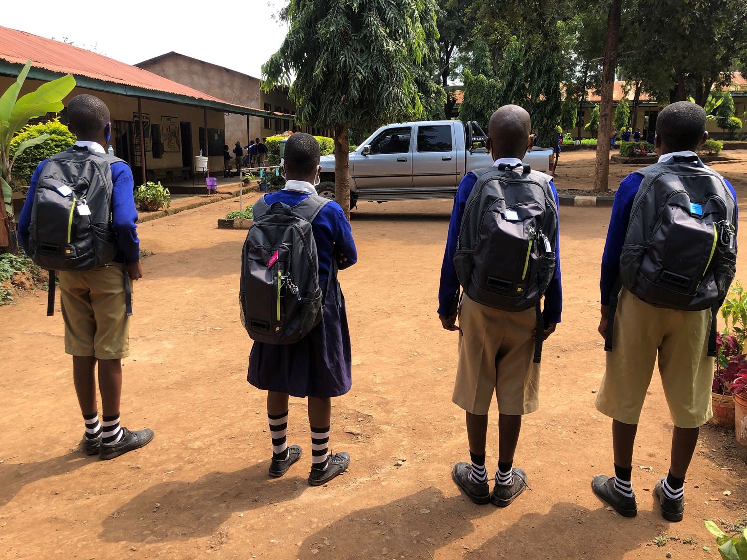 Schoolchildren wearing the Dyson air quality measuring back pack