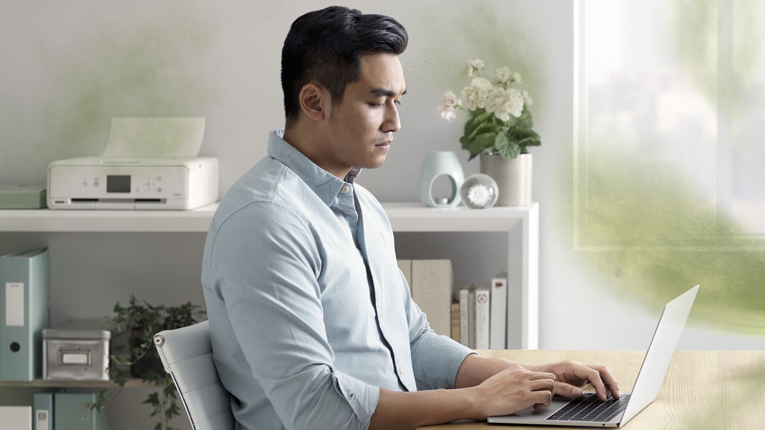 Man sitting down working on his computer
