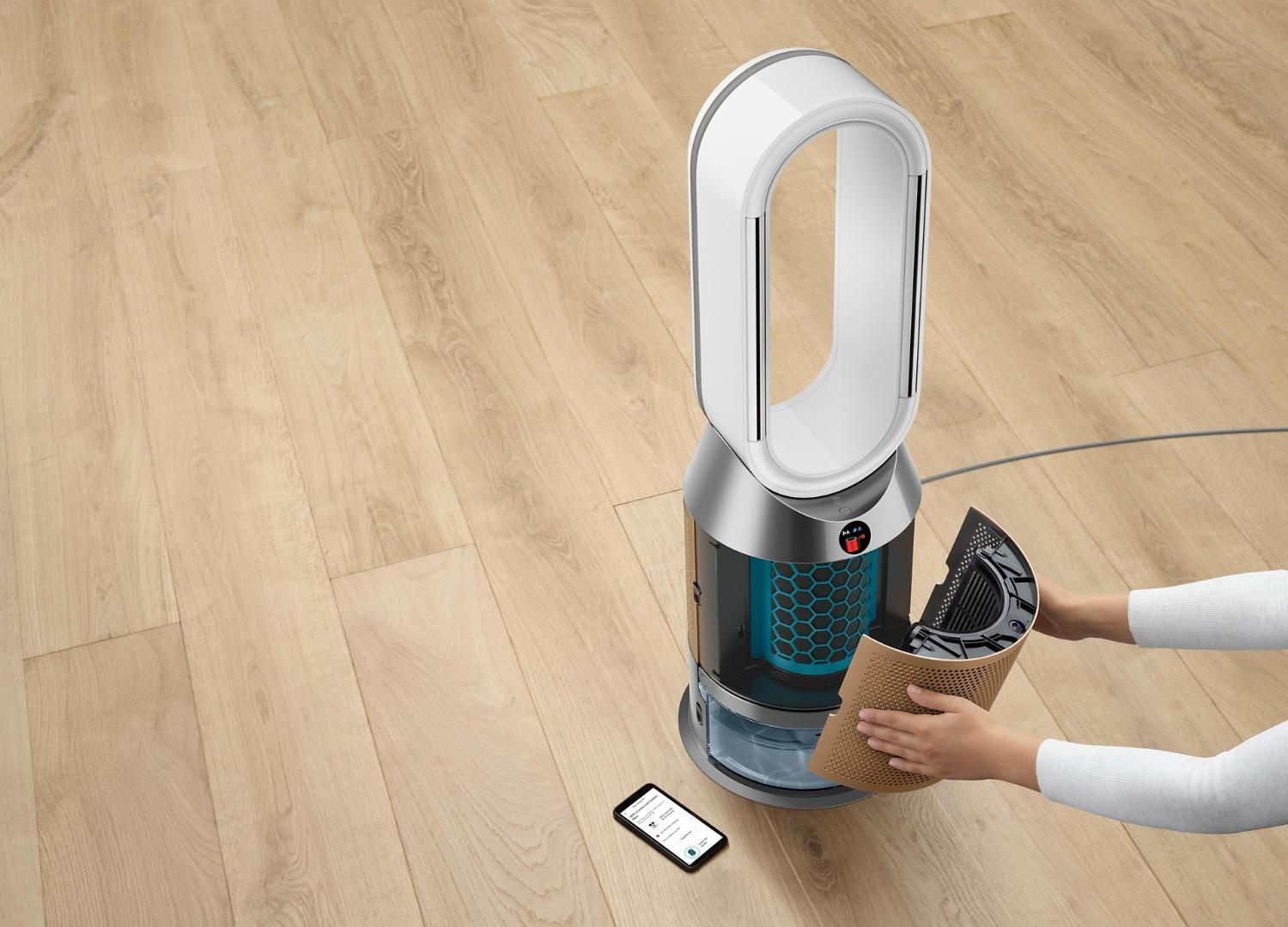 Woman taking purifier humidifier apart to clean the water tank