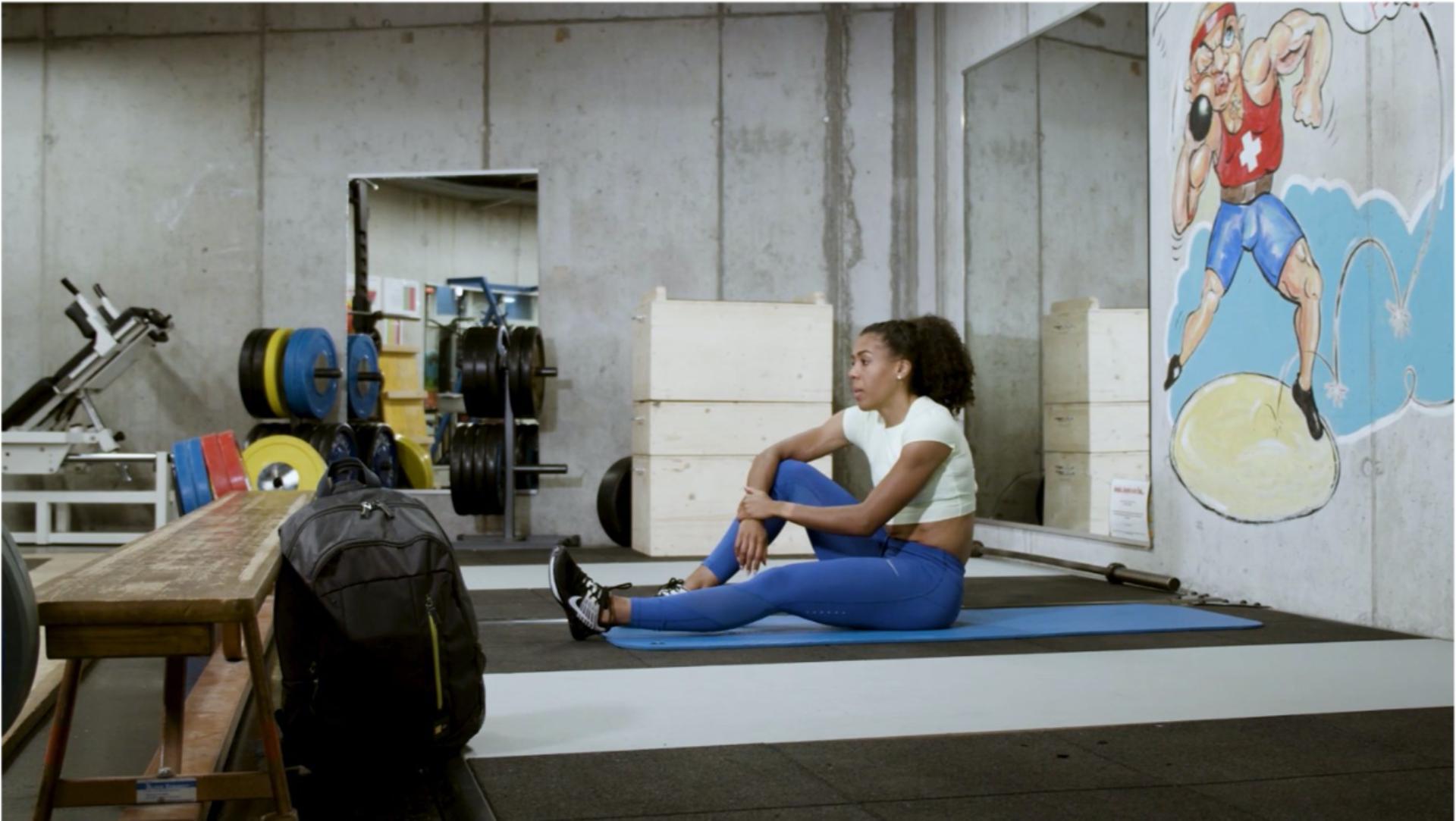 Mujinga Kambundji sitting on gym floor