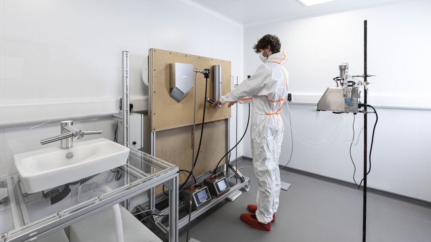 A Dyson Airblade handdryer in a bathroom.