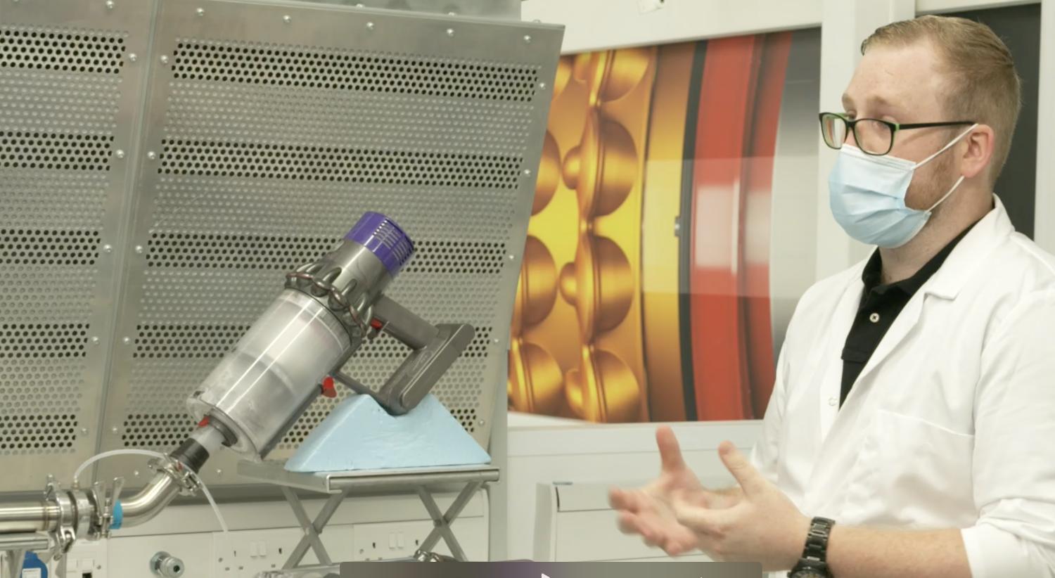 Engineers working on a vacuum.