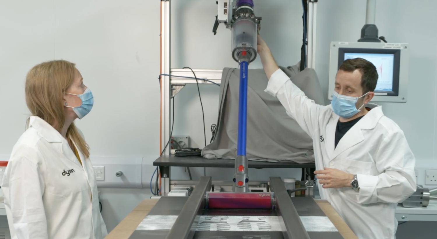 Engineers working on a vacuum.