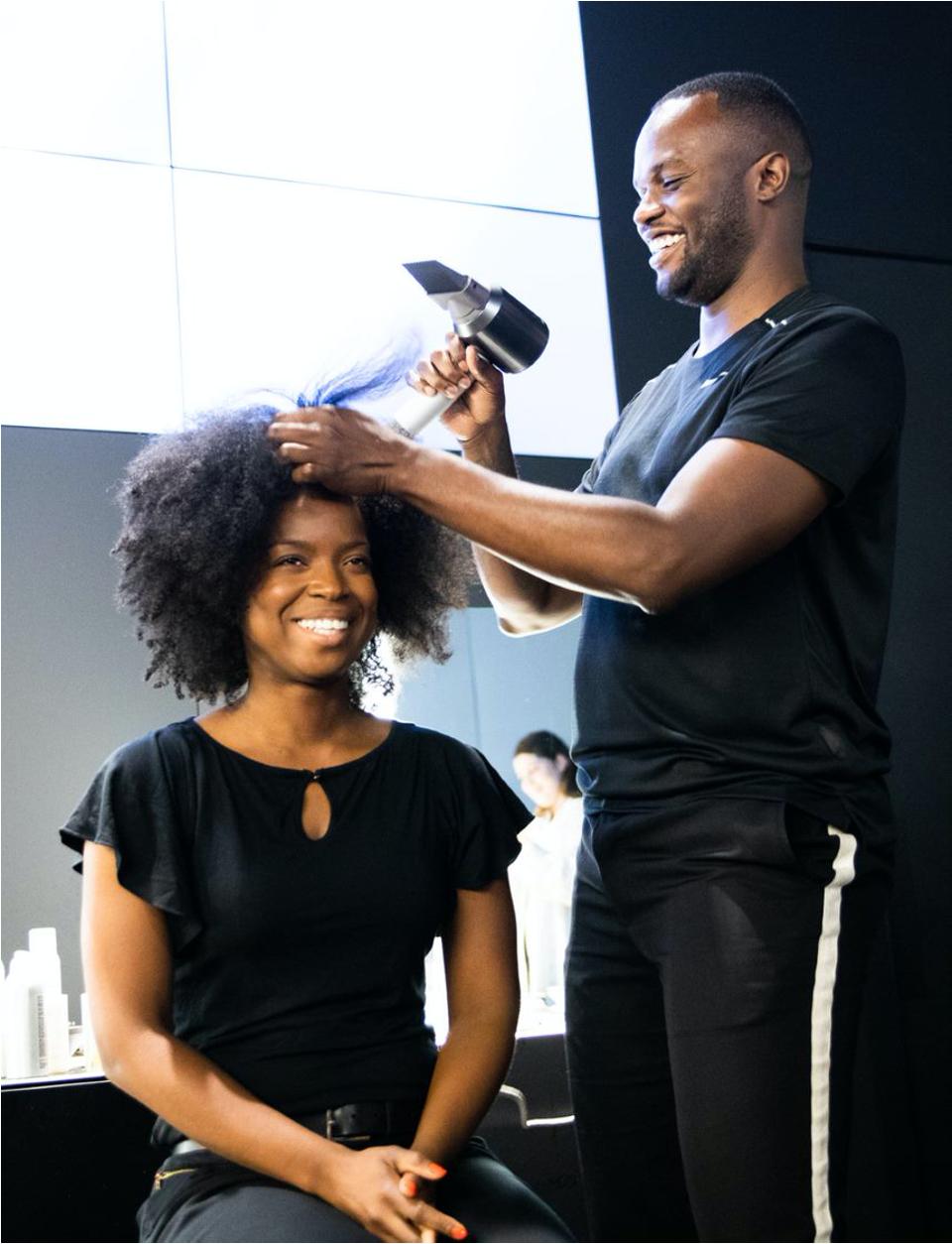 Dyson Ambassador Jawara Wauchope using the wide tooth comb on the Dyson Supersonic.