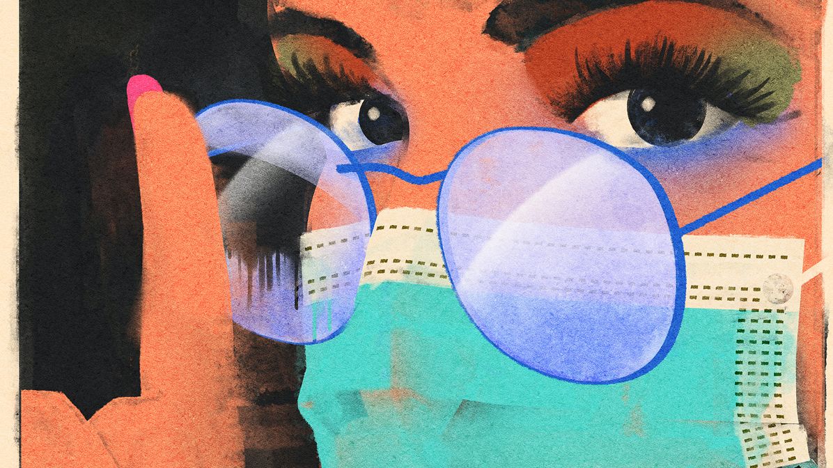 A woman wears a mask with glasses.