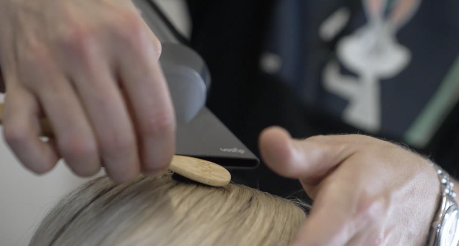 Man styling hair.