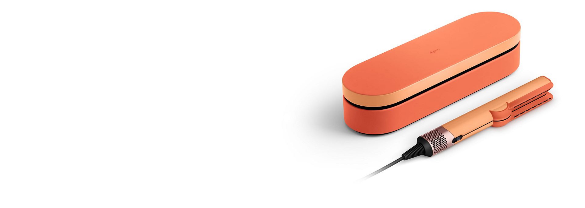 The Dyson Airstrait™ straightener and Presentation case in the Ceramic apricot colourway.