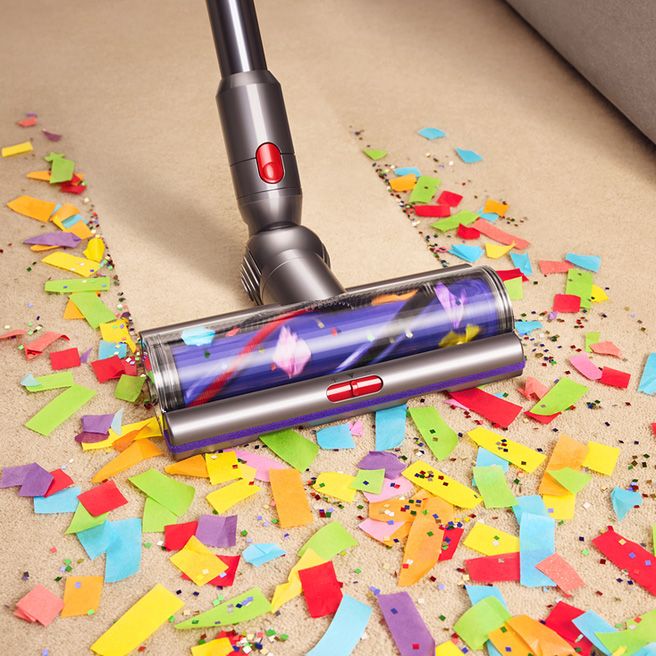 The Dyson Motorbar cleaner head is used to clean confetti and glitter from a hard floor.