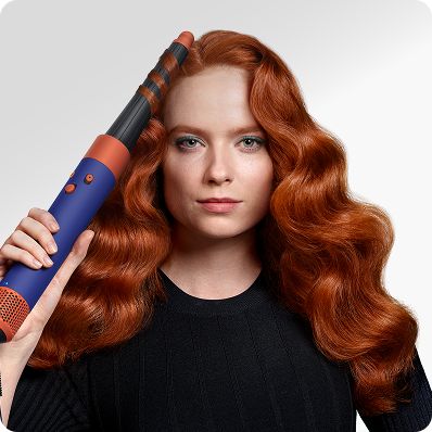 A model curls her hair with the Airwrap i.d. multi-styler and dryer.