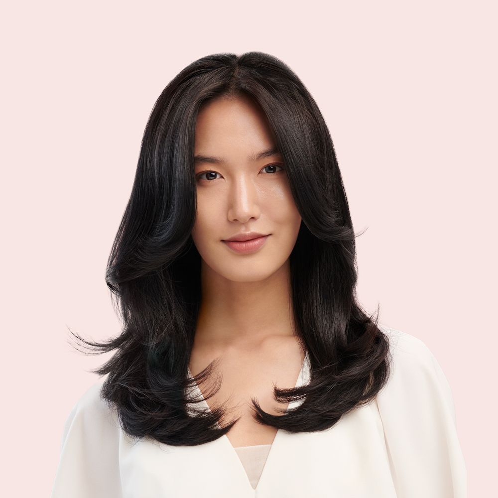 Model shows off her hair styled with the Dyson Airwrap Origin multi-styler and dryer.