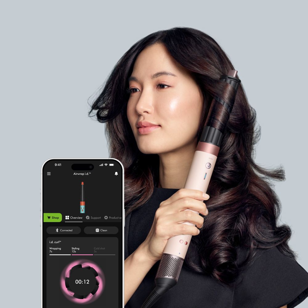 Dyson Airwrap Co-anda2x multi-styler and dryer used by a model with the MyDyson app to curl her hair.