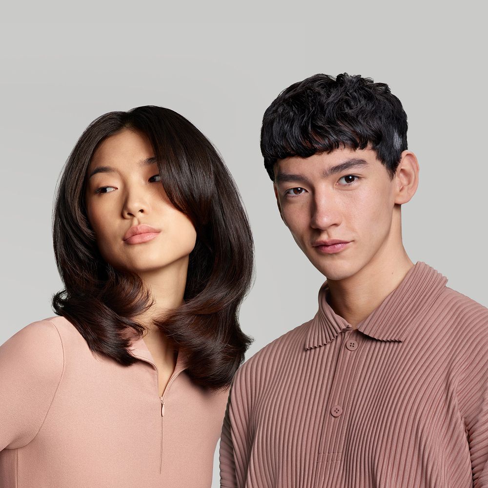 A pair of models with their hair styled with the Dyson Supersonic Nural hair dryer.