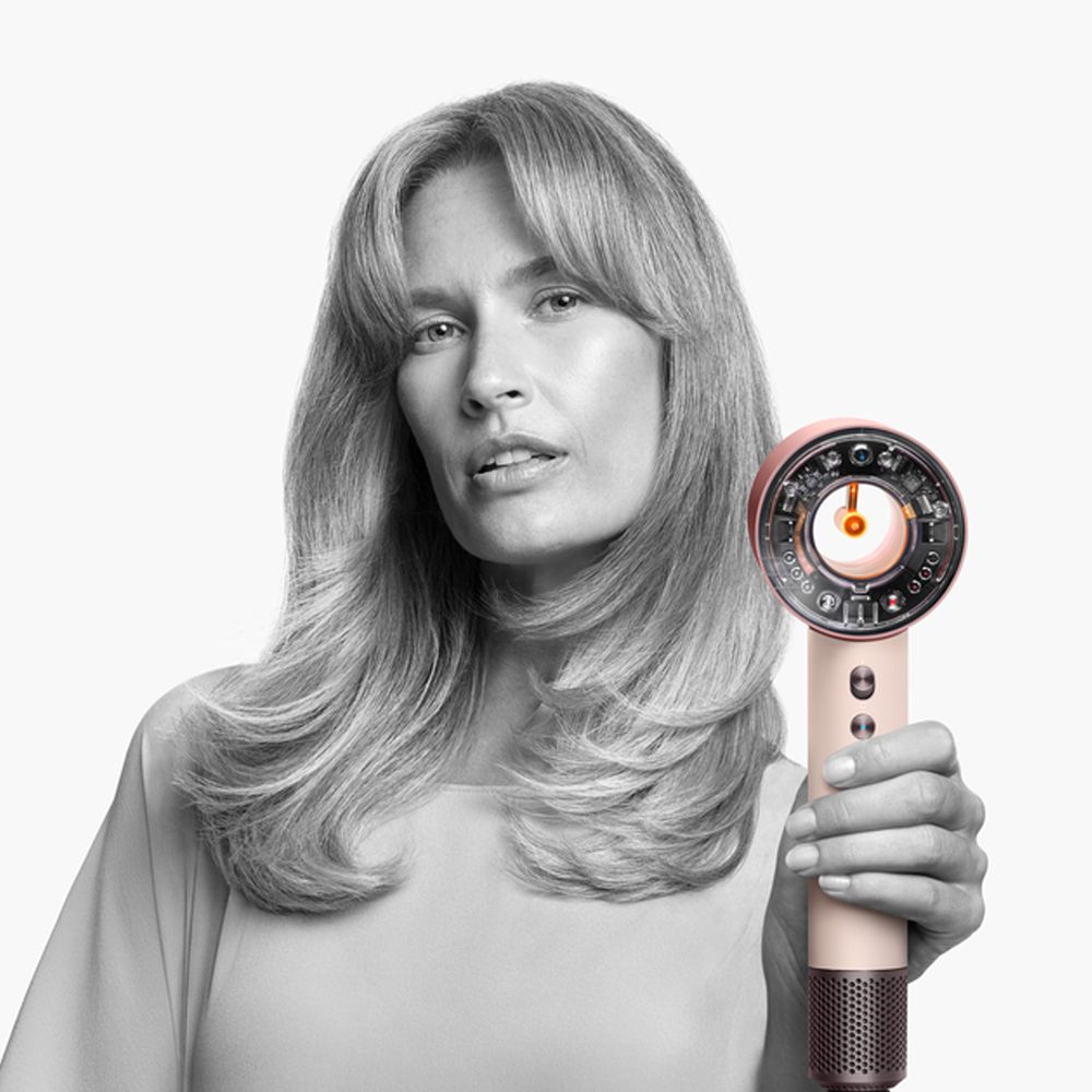 A model holds the Dyson Supersonic Nural hair dryer.