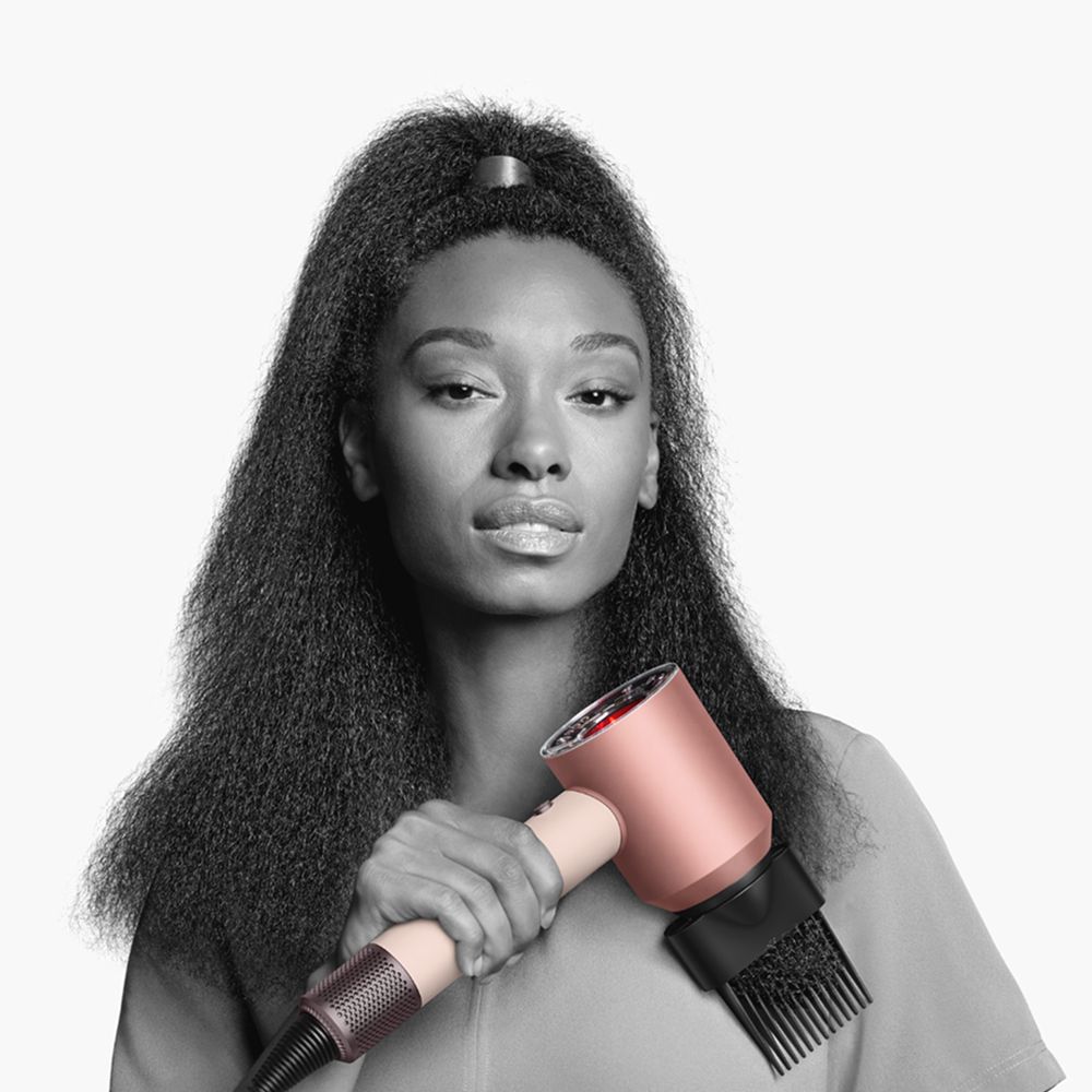 A model holds the Dyson Supersonic Nural hair dryer.