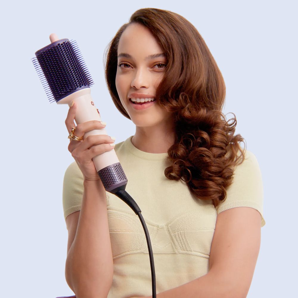 A model with her hair styled and dried with the Dyson Supersonic Travel hair dryer.