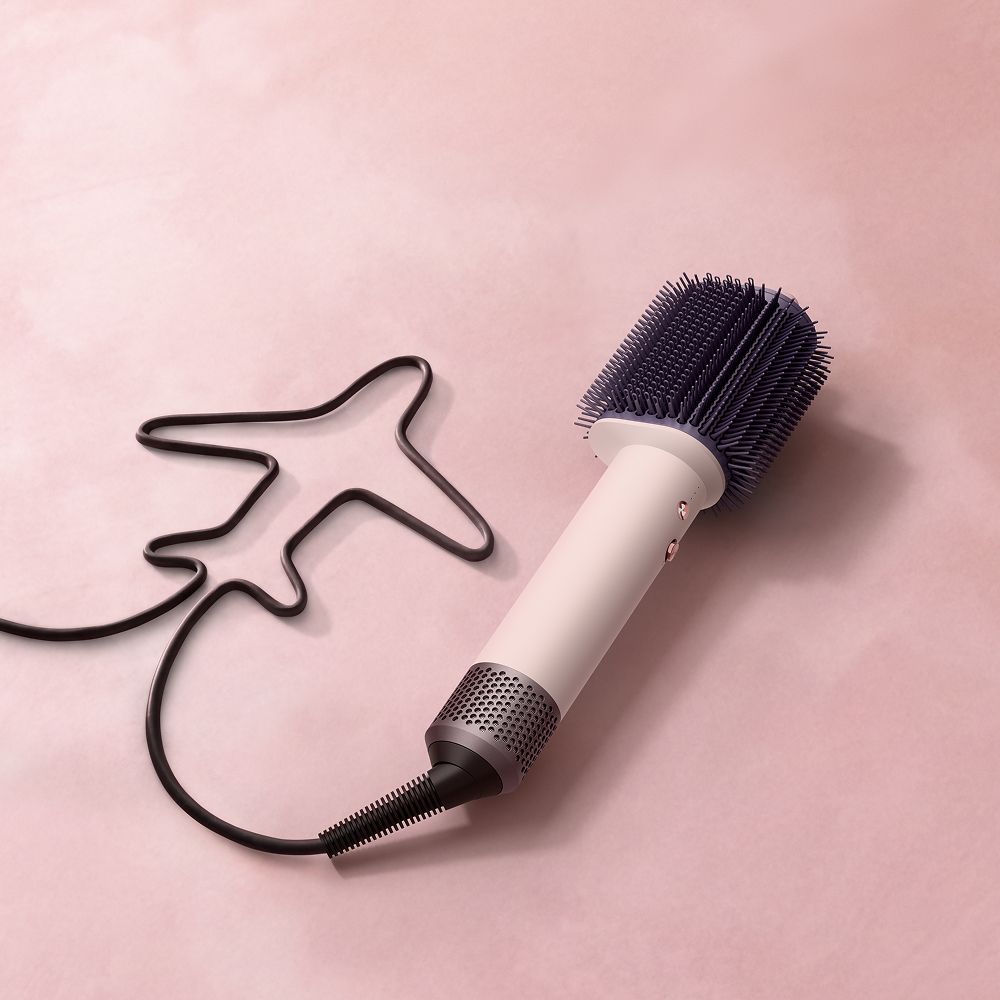 Dyson Airsmooth styling brush on a surface.