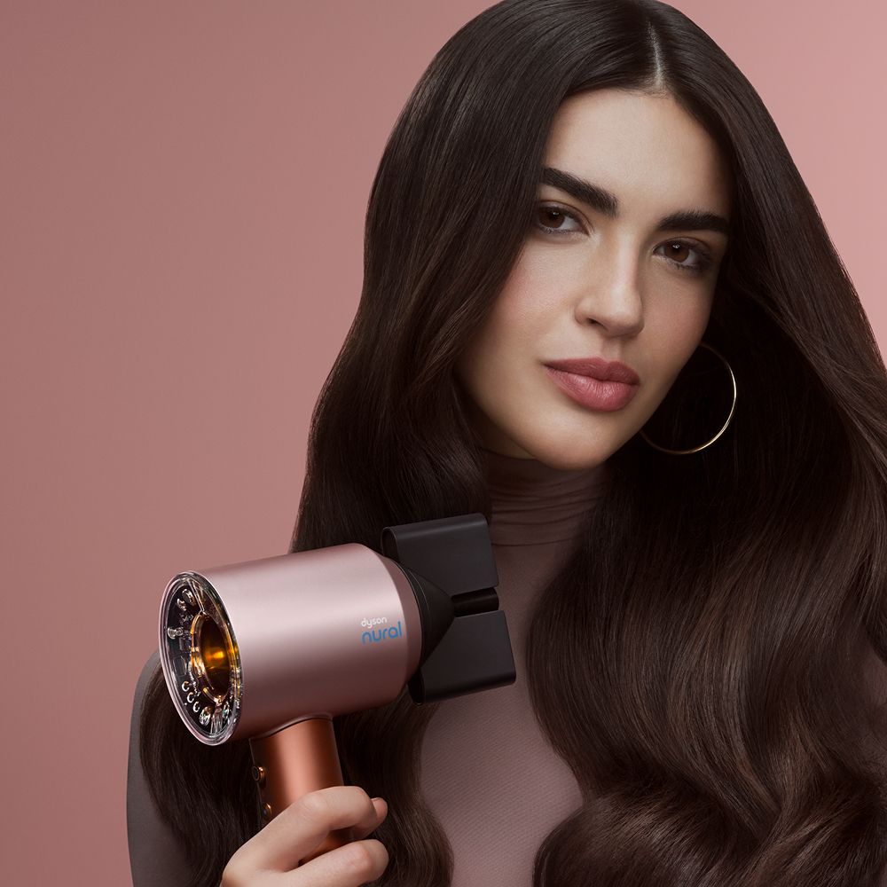 Model shows off her hair styled using the Dyson Supersonic Nural hair dryer.