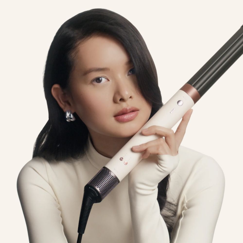 Model holds the Dyson Airwrap Co-anda2x multi-styler and dryer.
