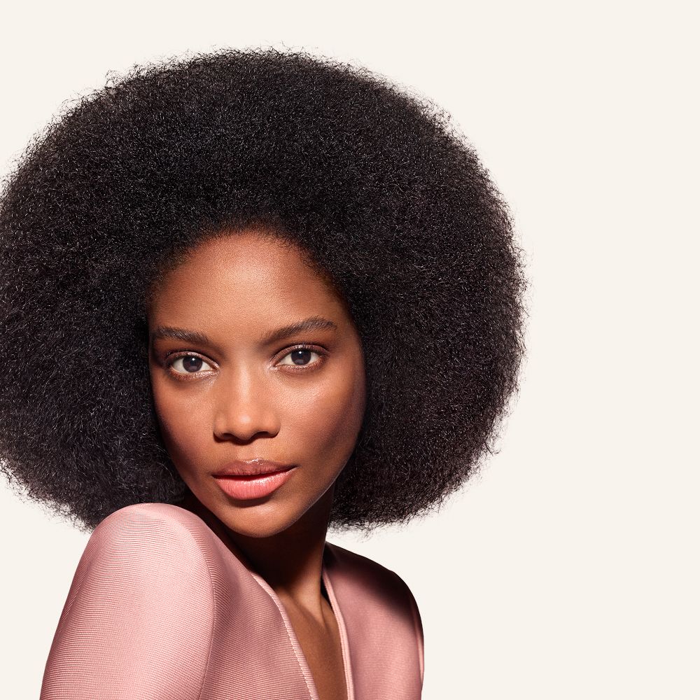 Model with hair styled using the Dyson Airwrap Co-anda2x multi-styler and dryer.